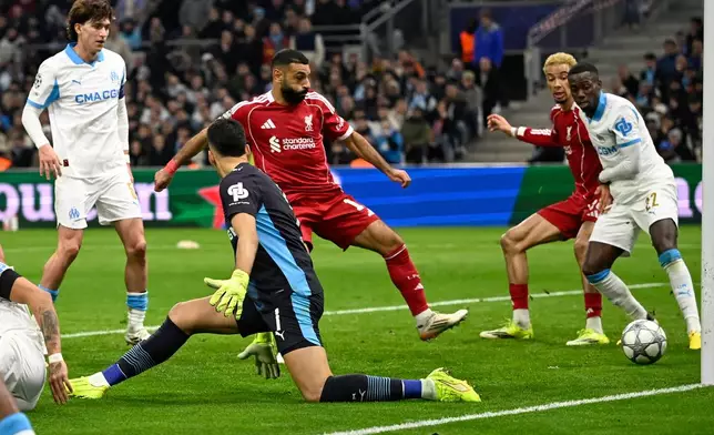 Marseille's goalkeeper Geronimo Rulli, left, scores an own goal during the Champions League opening phase soccer match between Marseille and Liverpool in Marseille, France, Wednesday, Jan. 21, 2026. (AP Photo/Philippe Magoni)