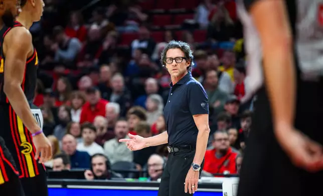 Atlanta Hawks Head Coach Quin Snyder looks to the referees during the first half of an NBA basketball game against the Portland Trail Blazers on Thursday, Jan. 15, 2026, in Portland, Ore. (AP Photo/Molly J. Smith)
