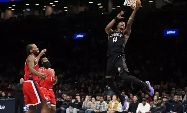 Brooklyn Nets' Terance Mann (14) drives past LA Clippers' James Harden (1) and Kawhi Leonard (2) during the first half of an NBA basketball game Friday, Jan. 9, 2026, in New York. (AP Photo/Frank Franklin II)