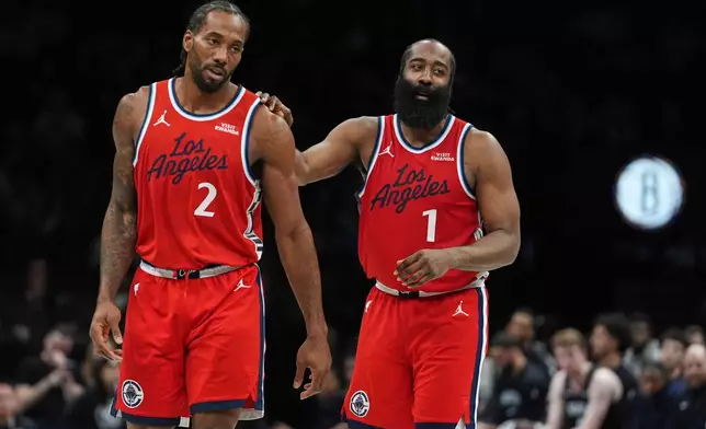 LA Clippers' James Harden (1) talks to Kawhi Leonard (2) during the second half of an NBA basketball game against the Brooklyn Nets Friday, Jan. 9, 2026, in New York. (AP Photo/Frank Franklin II)