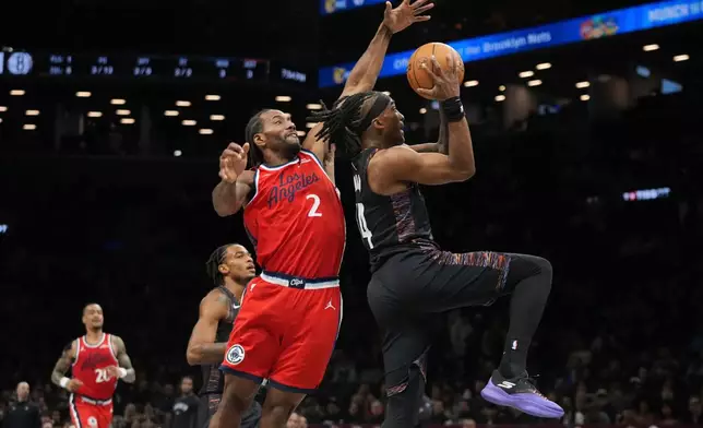 Brooklyn Nets' Terance Mann, right, drives past LA Clippers' Kawhi Leonard during the first half of an NBA basketball game Friday, Jan. 9, 2026, in New York. (AP Photo/Frank Franklin II)