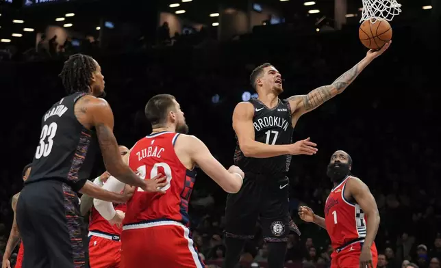 Brooklyn Nets' Michael Porter Jr. (17) drives past LA Clippers' James Harden (1) and Ivica Zubac (40) during the first half of an NBA basketball game Friday, Jan. 9, 2026, in New York. (AP Photo/Frank Franklin II)