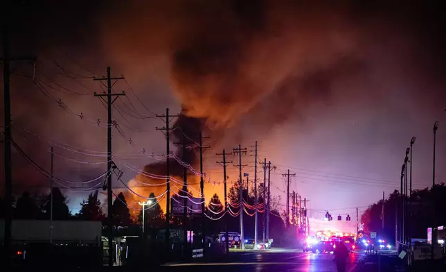 FILE - Plumes of smoke rise from the area of a UPS cargo plane crash at Louisville Muhammad Ali International Airport, on Tuesday, Nov. 4, 2025, in Louisville, Ky. (AP Photo/Jon Cherry, File)