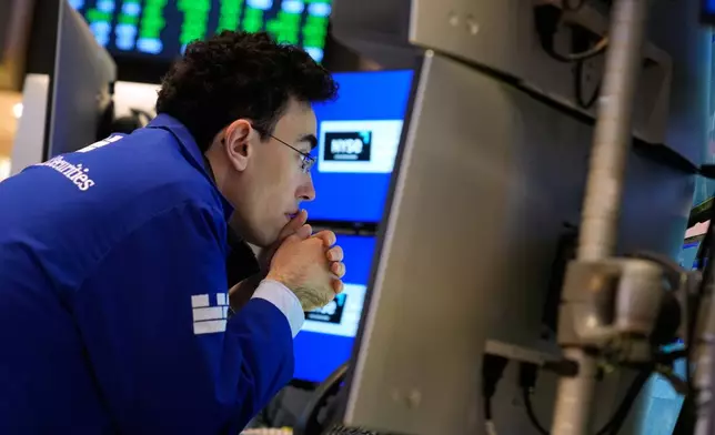 Alexander Weitzman works on the floor at the New York Stock Exchange in New York, Tuesday, Jan. 6, 2026. (AP Photo/Seth Wenig)