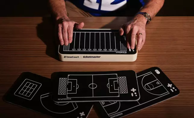 Clark Roberts, a blind Seattle Seahawks fan, uses a OneCourt tablet, a tactile device that translates gameplay into trackable vibrations along with real-time audio, at the T-Mobile Innovation Hub Tuesday, Jan. 27, 2026, in Bellevue, Wash. (AP Photo/Lindsey Wasson)
