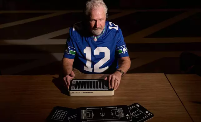 Clark Roberts, a blind Seattle Seahawks fan, uses a OneCourt tablet, a tactile device that translates gameplay into trackable vibrations along with real-time audio, at the T-Mobile Innovation Hub Tuesday, Jan. 27, 2026, in Bellevue, Wash. (AP Photo/Lindsey Wasson)