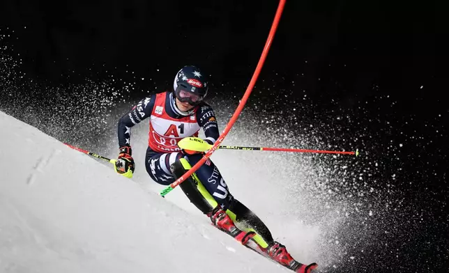 United States' Mikaela Shiffrin speeds down the course during an alpine ski, women¥s World Cup slalom, in Flachau, Austria, Tuesday, Jan. 13, 2026. (AP Photo/Marco Trovati)