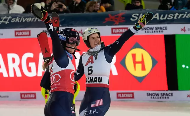 United States' Mikaela Shiffrin, left, poses with United States' Paula Moltzan at the finish line during an alpine ski, women's World Cup slalom, in Flachau, Austria, Tuesday, Jan. 13, 2026. (AP Photo/Giovanni Auletta)