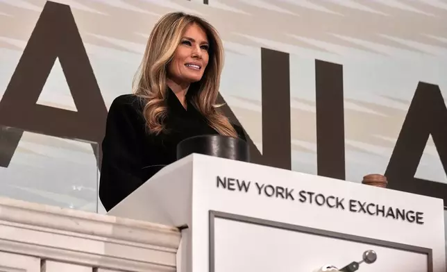 First lady Melania Trump poses for photos on the podium after ringing the New York Stock Exchange opening bell, Wednesday, Jan. 28, 2026. (AP Photo/Richard Drew)