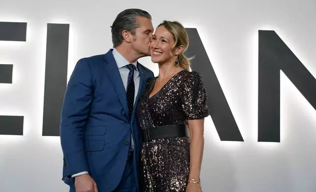Defense Secretary Pete Hegseth and his wife Jennifer arrive for the premiere of first lady Melania Trump's movie "Melania" at The John F. Kennedy Memorial Center For The Performing Arts, Thursday, Jan. 29, 2026, in Washington. (AP Photo/Jose Luis Magana)