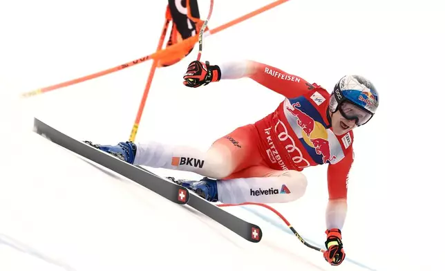 Switzerland's Marco Odermatt speeds down the course during a men's alpine ski World Cup downhill, in Kitzbuehel, Austria, Saturday, Jan. 24, 2026. (AP Photo/Gabriele Facciotti)