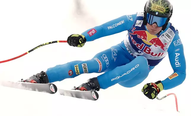 Italy's Giovanni Franzoni speeds down the course during a men's alpine ski World Cup downhill, in Kitzbuehel, Austria, Saturday, Jan. 24, 2026. (AP Photo/Gabriele Facciotti)