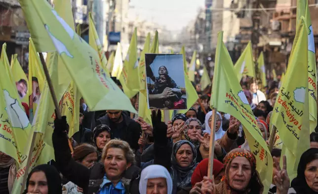 Demonstrators chant slogans in support of the Kurdish-led Syrian Democratic Forces (SDF) during a protest in Qamishli, northeastern Syria, Thursday, Jan. 8, 2026. (AP Photo/Hogir Al Abdo)