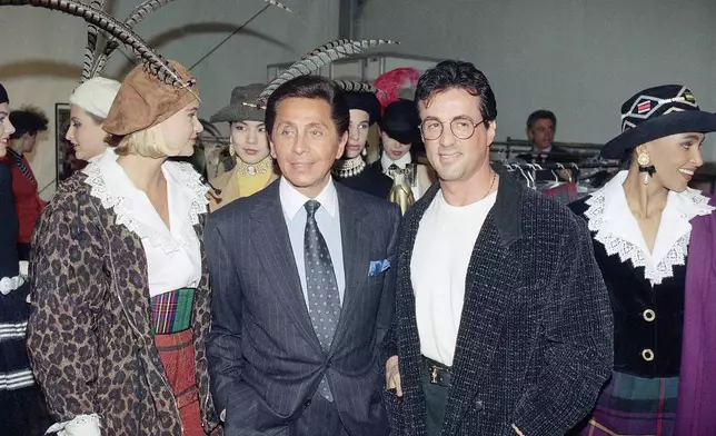 FILE - US actor Sylvester Stallone, right, meets Italian designer Valentino Garavani, left, ready to wear collection on March 17, 1991 in Paris, France. (AP Photo/Remy de la Mauviniere, File)