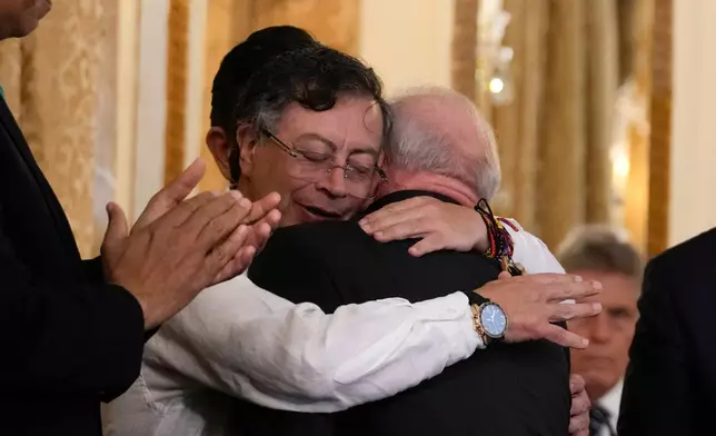 Colombian President Gustavo Petro embraces Brazilian President Luiz Inacio Lula da Silva after his decoration ceremony at the presidential palace in Panama City, Wednesday, Jan. 28, 2026. (AP Photo/Matias Delacroix)