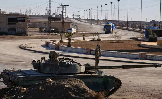 Soldiers of the Kurdish-led, U.S.-backed Syrian Democratic Forces (SDF) deploy with armoured military vehicles to secure roads leading to Gweiran Prison which houses men accused of being an Islamic State (ISIS) fighters in Hassakeh, northeastern Syria, Monday, Jan. 19, 2026. (AP Photo/Baderkhan Ahmad)
