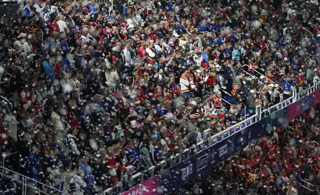 Fans watch before the NHL Winter Classic outdoor hockey game between the Florida Panthers and the New York Rangers, Friday, Jan. 2, 2026, in Miami. (AP Photo/Rebecca Blackwell)