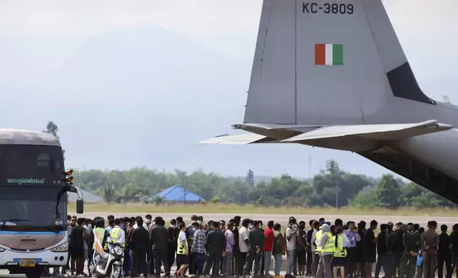 FILE -India nationals, believed to have worked at scam center in Myanmar, board a plane at Thailand's Mae Sot International Airport in Tak, before being sent back to India Nov. 6, 2025. (AP Photo/Sarot Meksophawannakul, File)