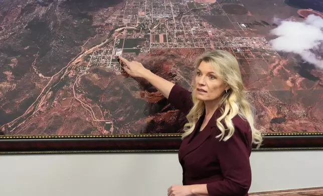 Hildale Mayor Donia Jessop points to an aerial photograph of Hildale during an interview Thursday, Dec. 4, 2025, in Hildale, Ut. (AP Photo/Rick Bowmer)