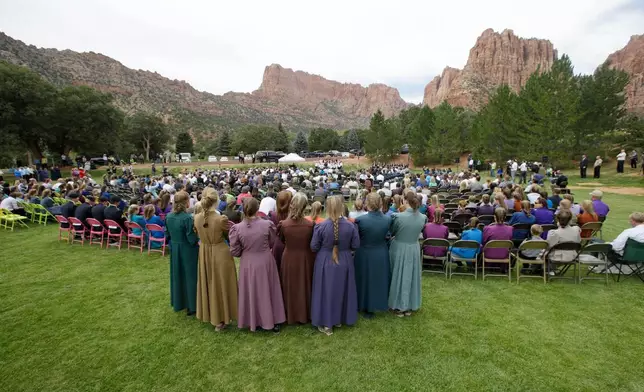 FILE - Two polygamous towns on the Utah-Arizona border hold a public memorial for women and children swept away in a deadly flash flood. (AP Photo/Rick Bowmer, File)