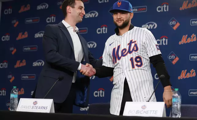 Bo Bichette, right, shakes hands with David Stearns, President of Baseball Operations for the New York Mets, during his introductory press conference, Wednesday, Jan. 21, 2026, in New York. (AP Photo/Heather Khalifa)
