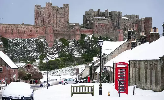 Bamburgh Castle surrounded by snow in Bamburgh, England, Tuesday, Jan. 6, 2026. (Owen Humphreys/PA via AP)