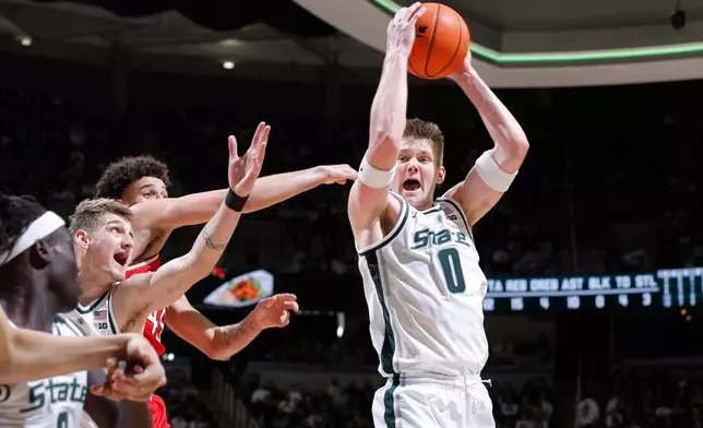 Michigan State forward Jaxon Kohler (0), right, grabs a rebound against Maryland center Collin Metcalf (45), rear, as Michigan State center Carson Cooper and guard Kur Teng, left, watch during the first half of an NCAA college basketball game, Saturday, Jan. 24, 2026, in East Lansing, Mich. (AP Photo/Al Goldis)