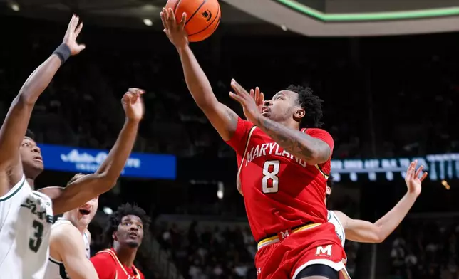 Maryland guard David Coit (8), right, puts up a layup against Michigan State forward Cam Ward (3) during the first half of an NCAA college basketball game, Saturday, Jan. 24, 2026, in East Lansing, Mich. (AP Photo/Al Goldis)