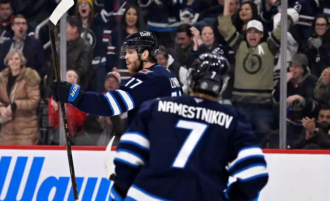 Winnipeg Jets' Adam Lowry (17) celebrates his goal against the New York Islanders during the second period of their NHL hockey game in Winnipeg, Manitoba, Tuesday, Jan. 13, 2026. (Fred Greenslade/The Canadian Press via AP)