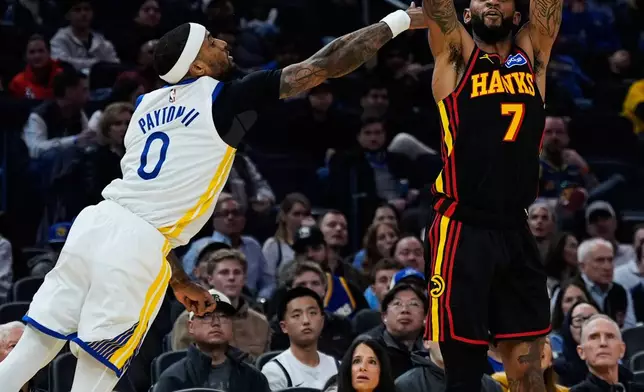 Atlanta Hawks guard Nickeil Alexander-Walker (7) shoots a 3-point basket next to Golden State Warriors guard Gary Payton II (0) during the first half of an NBA basketball game, Sunday, Jan. 11, 2026, in San Francisco. (AP Photo/Godofredo A. Vásquez)