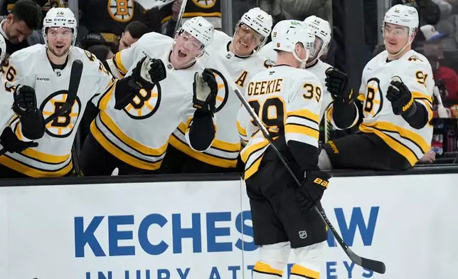 Boston Bruins center Morgan Geekie (39) celebrates his second period goal against the Montreal Canadiens in an NHL hockey game in Boston, Saturday, Jan. 24, 2026. (AP Photo/Robert F. Bukaty)