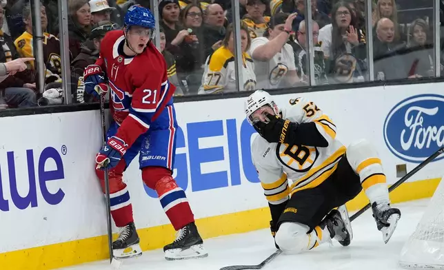 Boston Bruins center Sean Kuraly (52) covers his face after sustaining an injury battling Montreal Canadiens defenseman Kaiden Guhle (21) during the second period of an NHL hockey game against the Boston Bruins in Boston, Saturday, Jan. 24, 2026. (AP Photo/Robert F. Bukaty)