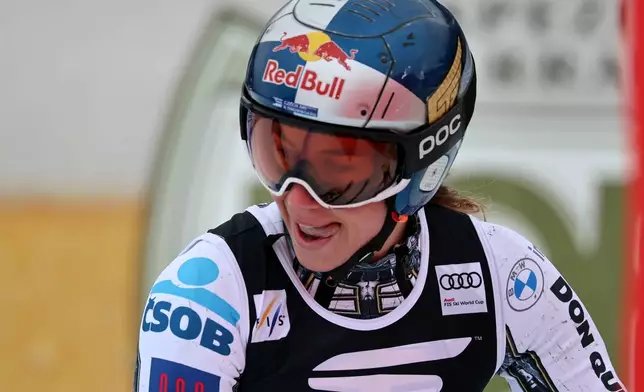 Czech Republic's Ester Ledecka celebrates at the finish area of an alpine ski, women's World Cup Super G, in Tarvisio, Italy, Sunday, Jan. 18, 2026. (AP Photo/Marco Trovati)