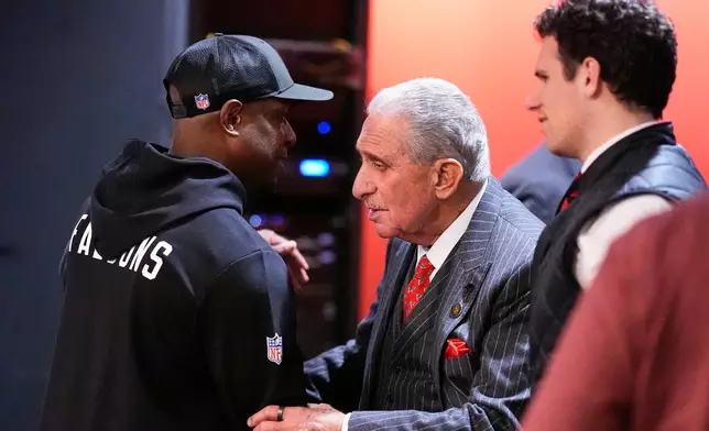 Atlanta Falcons owner Arthur Blank embraces head coach Raheem Morris after an NFL football game against the Los Angeles Rams, Monday, Dec. 29, 2025, in Atlanta. (AP Photo/Mike Stewart)