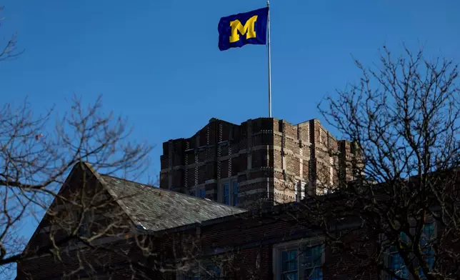 A flag blows in the wind atop the Michigan Union on the University of Michigan campus in Ann Arbor, Mich., Jan. 17, 2026. (AP Photo/Emily Elconin)