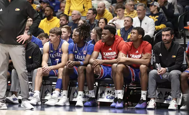 Kansas bench watches as they fall behind West Virginia during the second half of an NCAA college basketball game Saturday, Jan. 10, 2026, in Morgantown, W.Va. (AP Photo/Kathleen Batten)