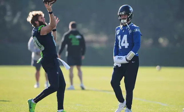 Seattle Seahawks quarterback Sam Darnold (14) watches wide receiver Cooper Kupp (10) throw during practice at the team's facilities ahead of the NFL football NFC Championship game, Wednesday, Jan. 21, 2026, in Renton, Wash. (AP Photo/Lindsey Wasson)