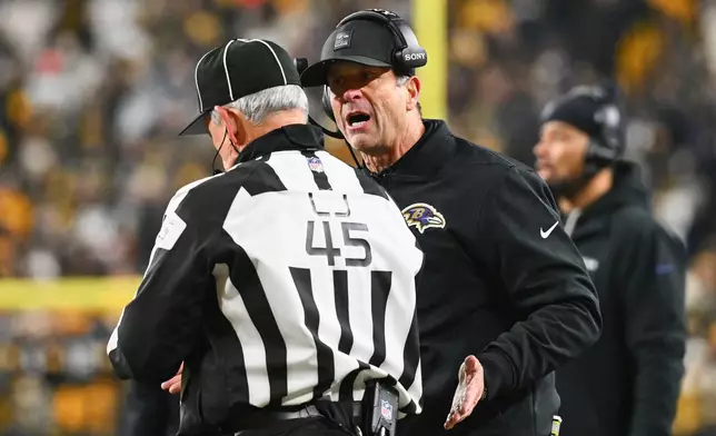 Baltimore Ravens head coach John Harbaugh talks with an offical during the second half of an NFL football game against the Pittsburgh Steelers, Sunday, Jan. 4, 2026, in Pittsburgh. (AP Photo/Justin Berl)