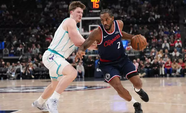 Los Angeles Clippers forward Kawhi Leonard (2) works around Charlotte Hornets guard/forward Kon Knueppel (7) during the first half of an NBA basketball game Monday, Jan. 12, 2026, in Inglewood, Calif. (AP Photo/Jae C. Hong)