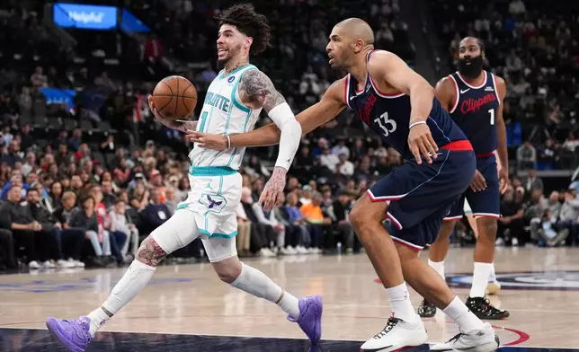 Charlotte Hornets guard LaMelo Ball (1) drives to the basket past Los Angeles Clippers guard/forward Nicolas Batum (33) during the second half of an NBA basketball game Monday, Jan. 12, 2026, in Inglewood, Calif. (AP Photo/Jae C. Hong)