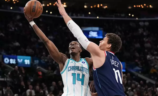 Charlotte Hornets forward Moussa Diabate (14) goes up for a basket under pressure by Los Angeles Clippers center Brook Lopez (11) during the second half of an NBA basketball game Monday, Jan. 12, 2026, in Inglewood, Calif. (AP Photo/Jae C. Hong)