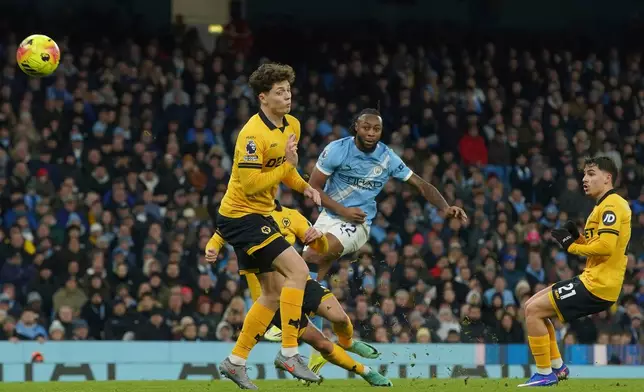 Manchester City's Antoine Semenyo, center, shoots and hits the bar during the English Premier League soccer match between Manchester City and Wolverhampton Wanderers in Manchester, England, Saturday, Jan. 24, 2026. (AP Photo/Ian Hodgson)