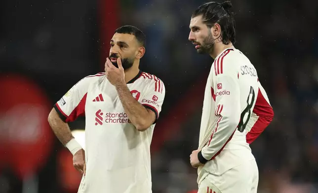 Liverpool's Mohamed Salah, left and teammate Dominik Szoboszlai talks before a direct free kick from which Liverpool's Dominik Szoboszlai scores his sides second goal during the English Premier League soccer match between Bournemouth and Liverpool in Bournemouth, England, Saturday, Jan. 24, 2026. (AP Photo/Ian Walton)