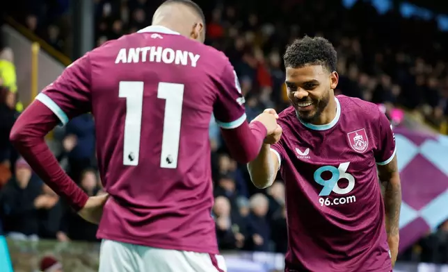 Burnley's Lyle Foster, right, celebrates with teammate Jaidon Anthony after scoring his side's second goal of the game, during the English Premier League soccer match between Burnley and Tottenham Hotspur, at Turf Moor, in Burnley, England, Saturday, Jan. 24, 2026. (Richard Sellers/PA via AP)