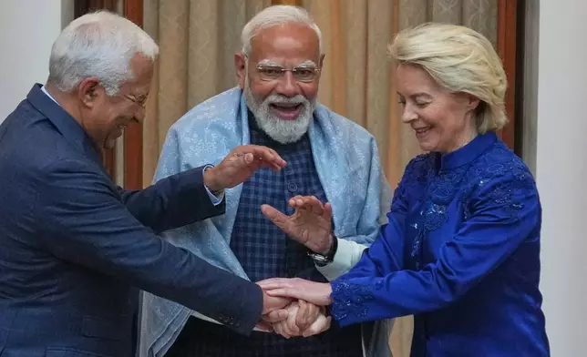 Indian Prime Minister Narendra Modi, center, welcomes European Council President Antonio Costa, left and European Commission President Ursula von der Leyen before their meeting in New Delhi, India, Tuesday, Jan. 27, 2026. (AP Photo/Manish Swarup)