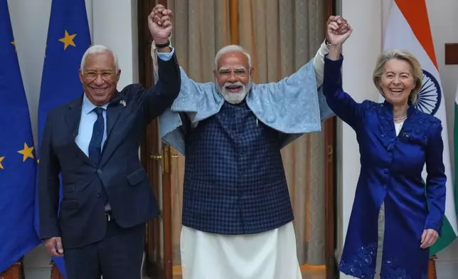 Indian Prime Minister Narendra Modi, center, welcomes European Council President Antonio Costa, left and European Commission President Ursula von der Leyen before their meeting in New Delhi, India, Tuesday, Jan. 27,2026. (AP Photo/Manish Swarup)