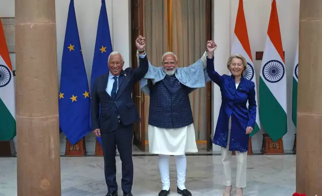 Indian Prime Minister Narendra Modi, center, welcomes European Council President Antonio Costa, left and European Commission President Ursula von der Leyen before their meeting in New Delhi, India, Tuesday, Jan. 27,2026. (AP Photo/Manish Swarup)