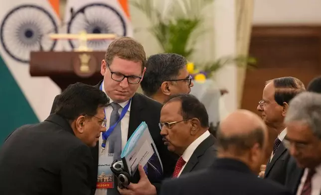 European Commission Commissioner for Trade and Economic Security Maros Sefcovic, second left, talks with Indian National Security Advisor, Ajit Doval, center, and Indian Minister for Commerce and Industry Piyush Goyal, left, before the announcement by Indian Prime Minister Narendra Modi, European Council President Antonio Costa and European Commission President Ursula von der Leyen about reaching free trade agreement between India and EU in New Delhi, India, Tuesday, Jan. 27, 2026. (AP Photo/Manish Swarup)