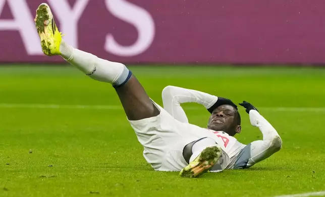 Tottenham's Randal Kolo Muani is on the ground during the Champions League opening phase soccer match between Eintracht Frankfurt and Tottenham Hotspurs in Frankfurt, Germany, Wednesday, January. 28, 2026. (AP Photo/Michael Probst)