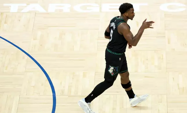 Minnesota Timberwolves guard Anthony Edwards (5) celebrates after scoring a three-point basket during the first half of an NBA basketball game against the Miami Heat, Tuesday, Jan. 6, 2026, in Minneapolis. (AP Photo/Ellen Schmidt)